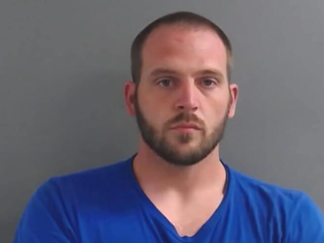 White male with beard wearing a blue tshirt