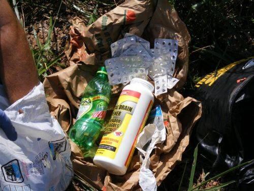 Drain cleaner, an empty soda bottle, and a large number of empty medicine containers.