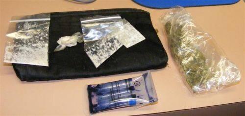 Miscellaneous drugs on a table next to a drug testing kit.